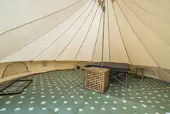 Winnie bell tent interior with double bed and two camp beds Winnie bell tent interior with double bed and two camp beds