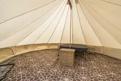 Dingle Bell bell tent interior with double bed and two camp beds Dingle Bell bell tent interior with double bed and two camp beds