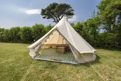 Winnie bell tent exterior with picnic bench Winnie bell tent exterior with picnic bench