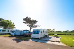 Fully serviced hardstanding touring pitches with electric, water and drainage Fully serviced hardstanding touring pitches with electric, water and drainage