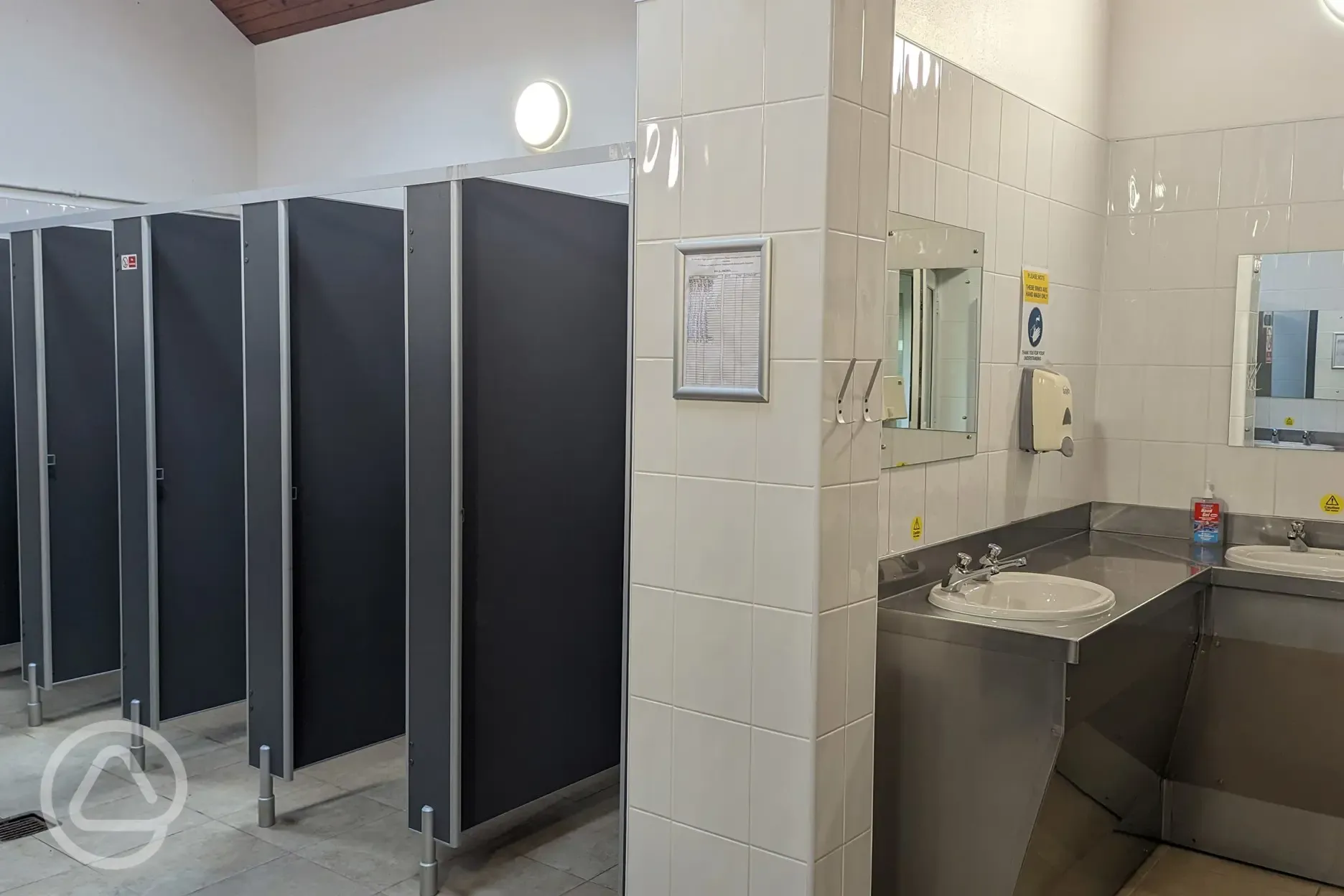 Ladies toilets with cubicles, showers, sinks and mirrors