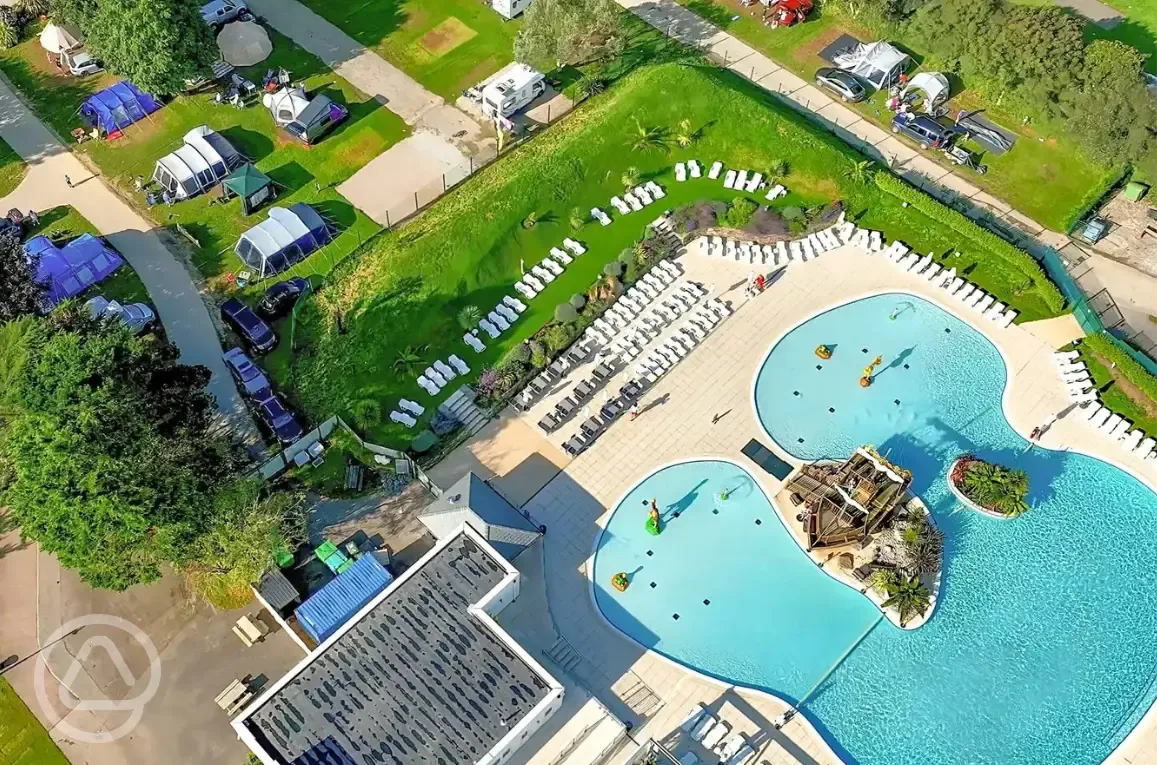 Aerial of the outdoor swimming pool, sun loungers and tent pitches