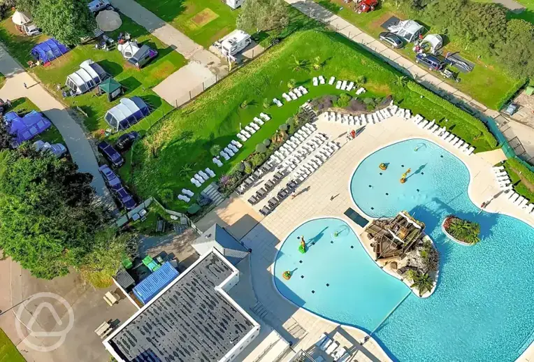 Aerial of the outdoor swimming pool, sun loungers and tent pitches