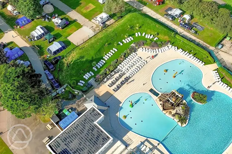 Aerial of the outdoor swimming pool, sun loungers and tent pitches