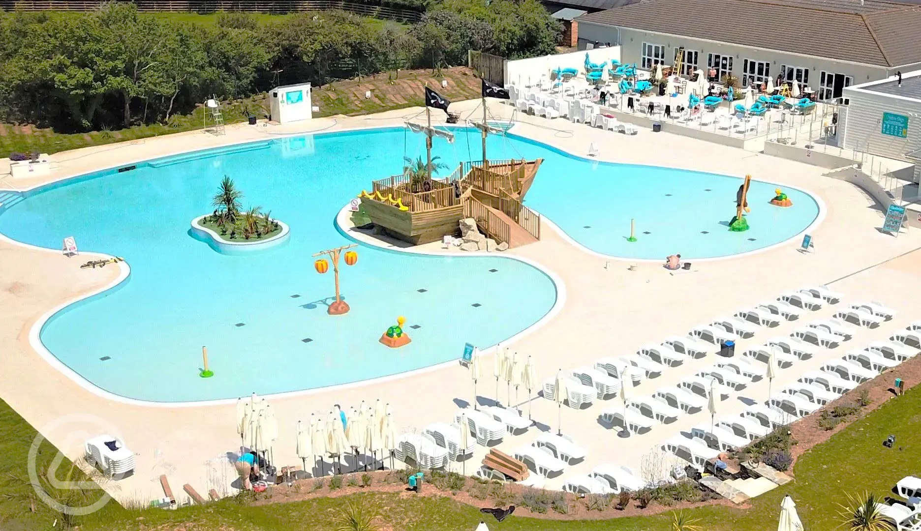 Swimming pool aerial view with sun loungers 