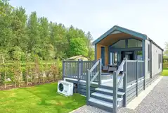 Glamping S-pod with an electric hot tub set in the decking