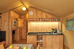 Safari tent kitchen with a sink, hob, kettle, fridge and freezer