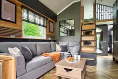Glamping S-pod interior with a double sofa bed and mezzanine double