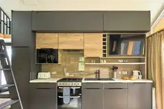 Glamping S-pod kitchen with a hob, sink, microwave and oven