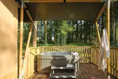Safari tent deck with an electric hot tub