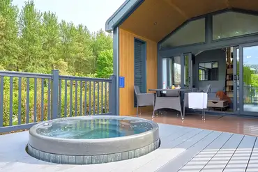 Glamping S-pod with an electric hot tub set in the decking