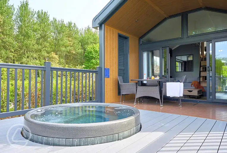 Glamping S-pod with an electric hot tub set in the decking