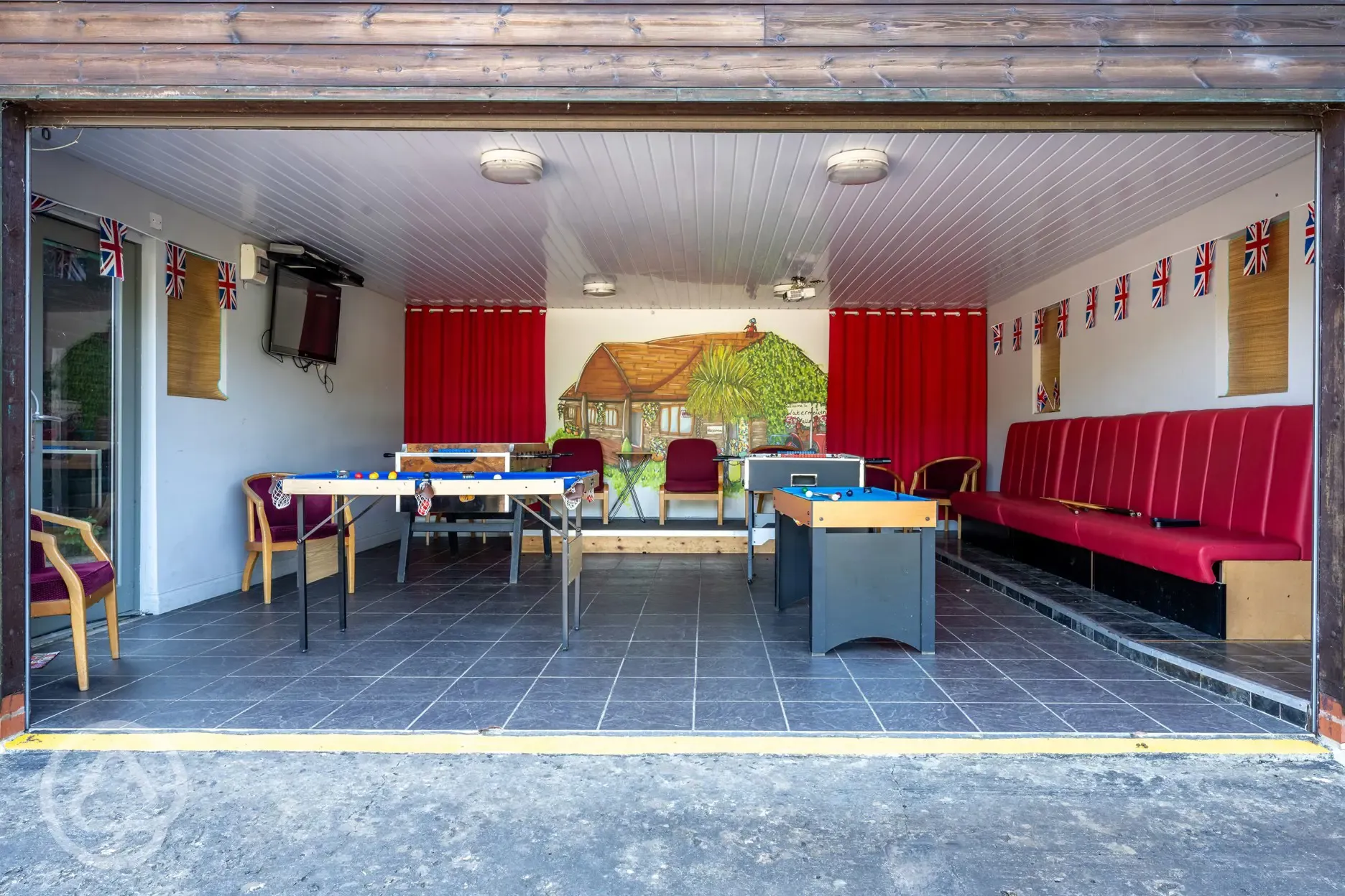 Games room with a TV and pool tables
