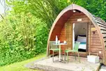 Camping pods with a small deck area and outdoor seating