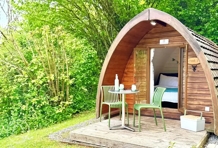 Camping pods with a small deck area and outdoor seating
