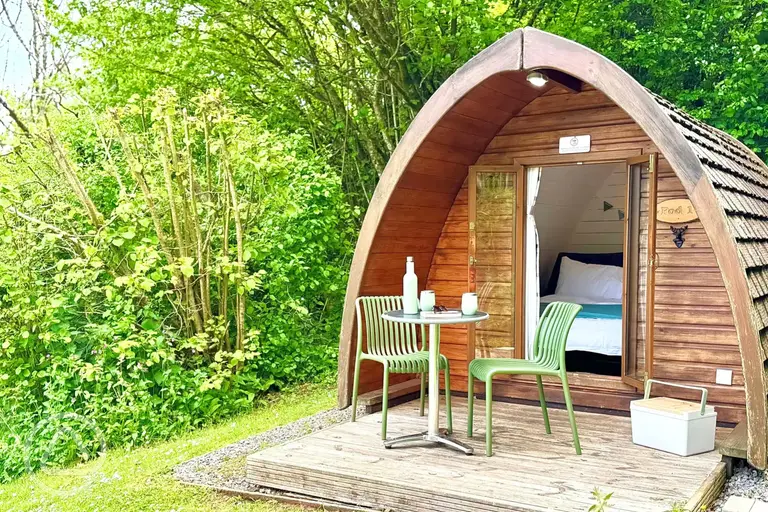 Camping pods with a small deck area and outdoor seating