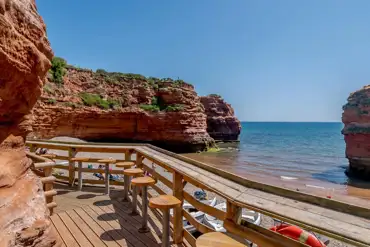 Beach shack seating at Pebbles Restaurant overlooking private Ladram Bay Beach