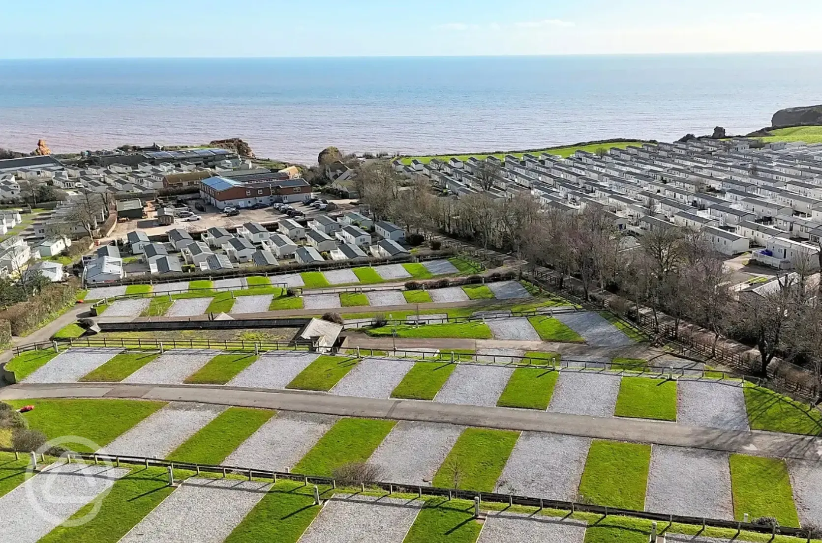 Aerial of the fully serviced hardstanding pitches and coast