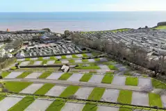 Aerial of the fully serviced hardstanding pitches and coast Aerial of the fully serviced hardstanding pitches and coast