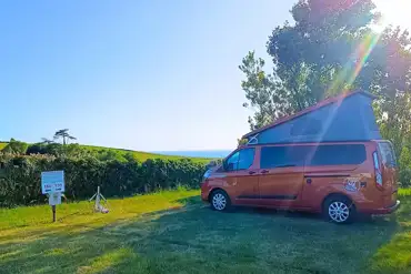 Electric grass campervan pitches with views towards Chesil Beach