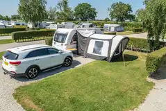 Standard electric hardstanding pitches with a grass area (12m x 10m) Standard electric hardstanding pitches with a grass area (12m x 10m)