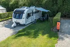 Standard electric hardstanding pitches with a grass area (12m x 10m) Standard electric hardstanding pitches with a grass area (12m x 10m)