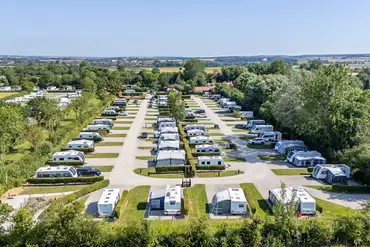 Tree-lined Black Bull Caravan Park with dividing hedges