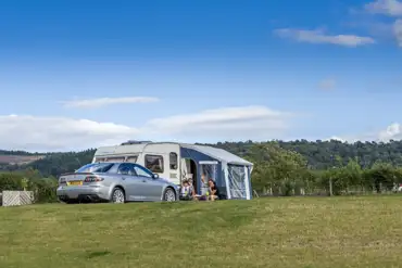 Electric grass touring pitches (10m x 6m) with awning space
