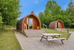 Deluxe Mega Pod exterior with stairs and a picnic bench