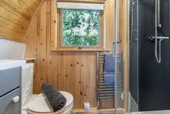 Five person glamping pod bathroom with a toilet and shower