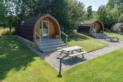 Glamping pods with adjacent grass areas