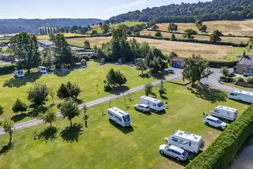 Aerial of the electric grass touring pitches with trees around site