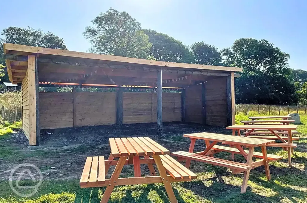 Camping shelter and picnic tables