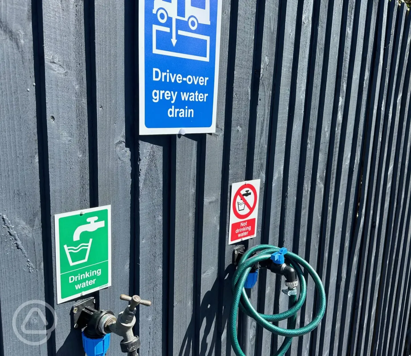 Drinking water tap and drive-over grey waste drainage point