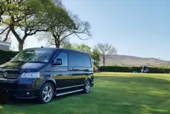 Electric grass touring pitches on gently sloping, well drained ground