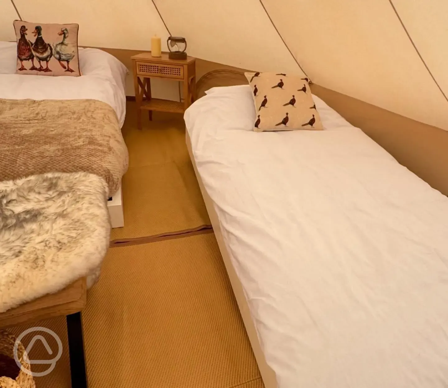 Bell tent interior single bed, with bedding provided