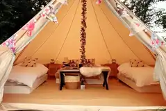 Bell tent exterior, sleeping up to four with outdoor firepit, table and chairs