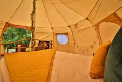 Bell tent interior with cosy furnishings