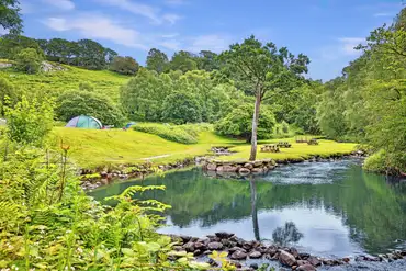 Grass camping pitches at Nantcol Waterfalls by the river