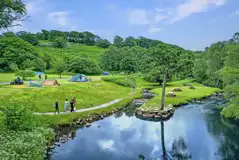 Grass camping pitches by the Nantcol river, perfect for paddling and fishing Grass camping pitches by the Nantcol river, perfect for paddling and fishing