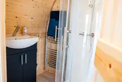 Luxury ensuite glamping pod ensuite with shower, heated towel rail and sink