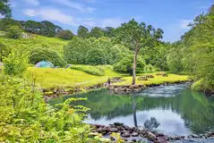 Grass camping pitches by the river