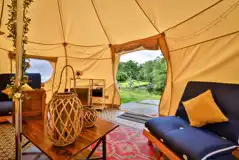 Bell tent interior with lighting, electric and a cool box