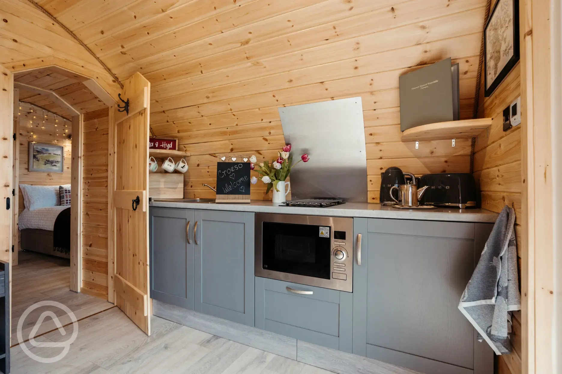 Luxury ensuite glamping pod kitchen with combi microwave, hob and fridge freezer Luxury ensuite glamping pod kitchen with combi microwave, hob and fridge freezer