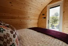 Luxury ensuite glamping pod bedroom with outdoor views
