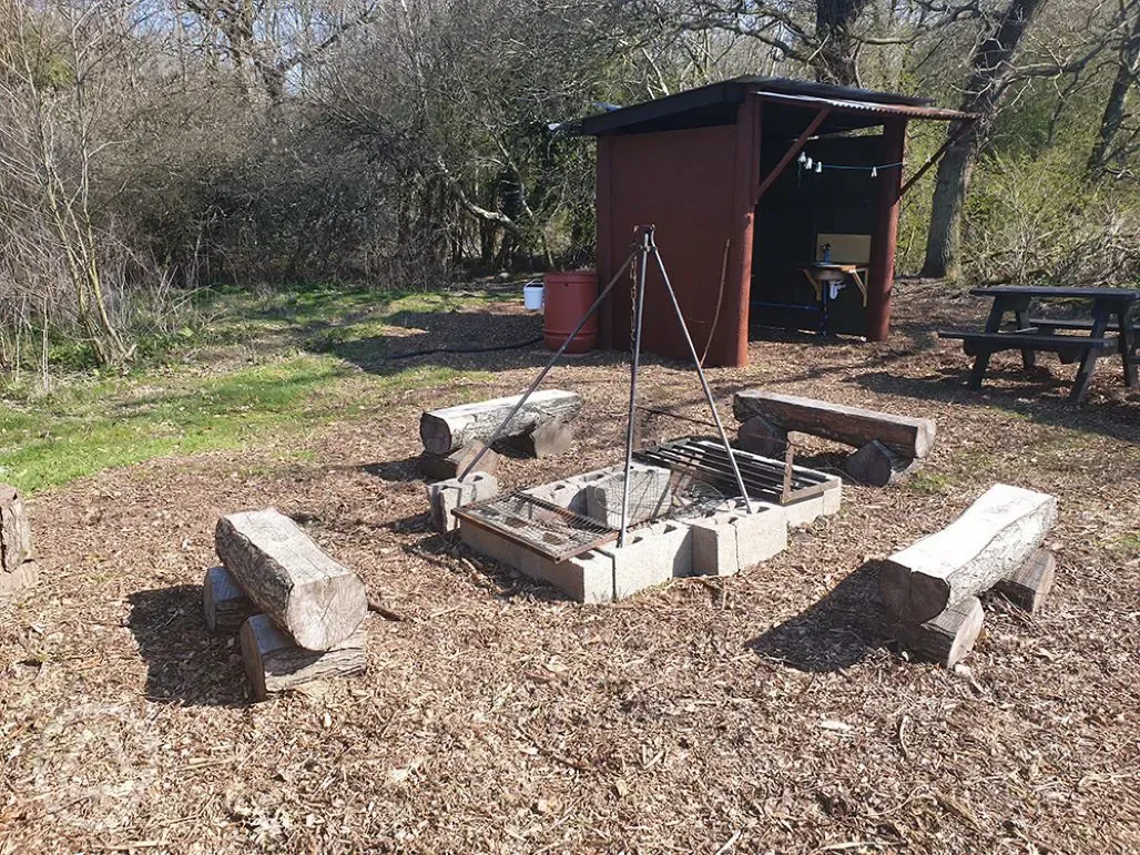 Covered area and fire pit in meadow pitches