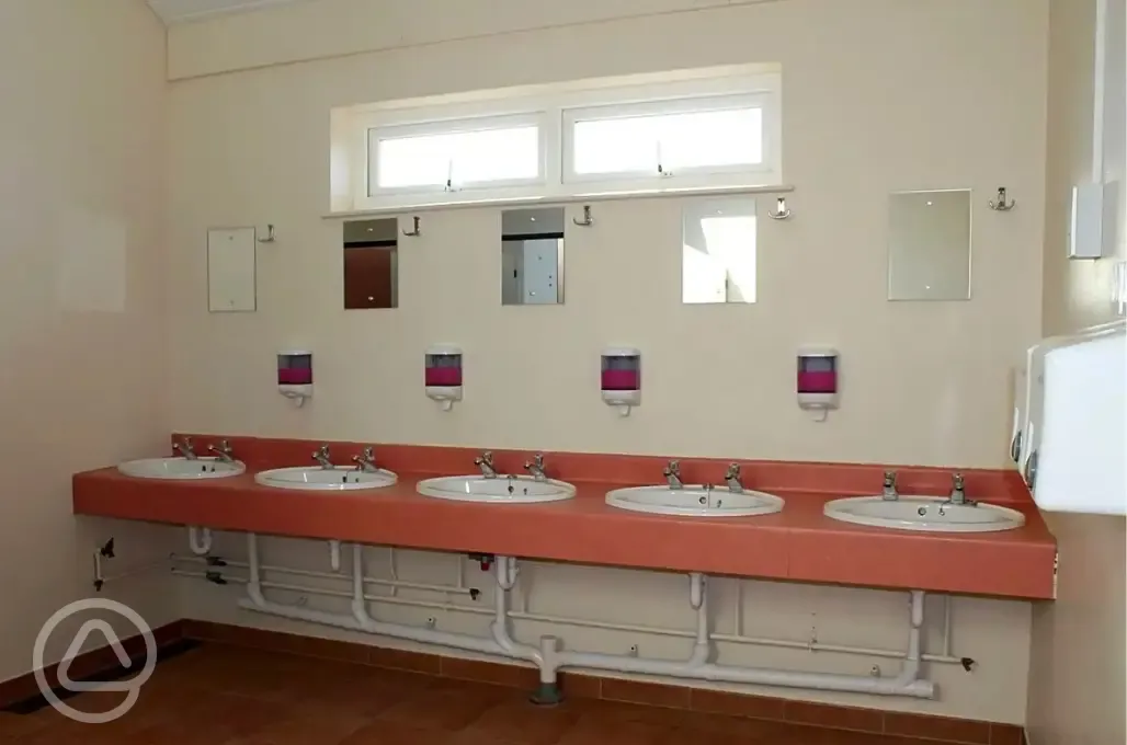 Hand basins with soap dispensers