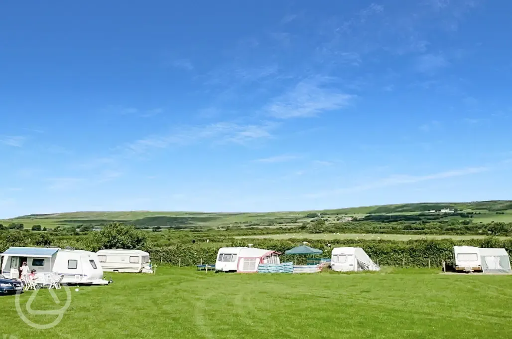 Grass pitches at Kennexstone Park with hill views in the background