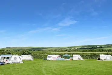Grass pitches at Kennexstone Park with hill views in the background