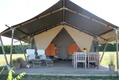 Safari tent exterior with outdoor seating Safari tent exterior with outdoor seating